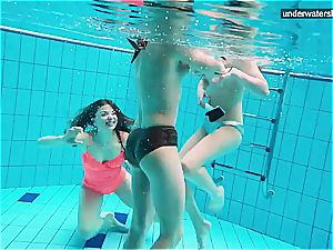 three naked ladies have fun underwater